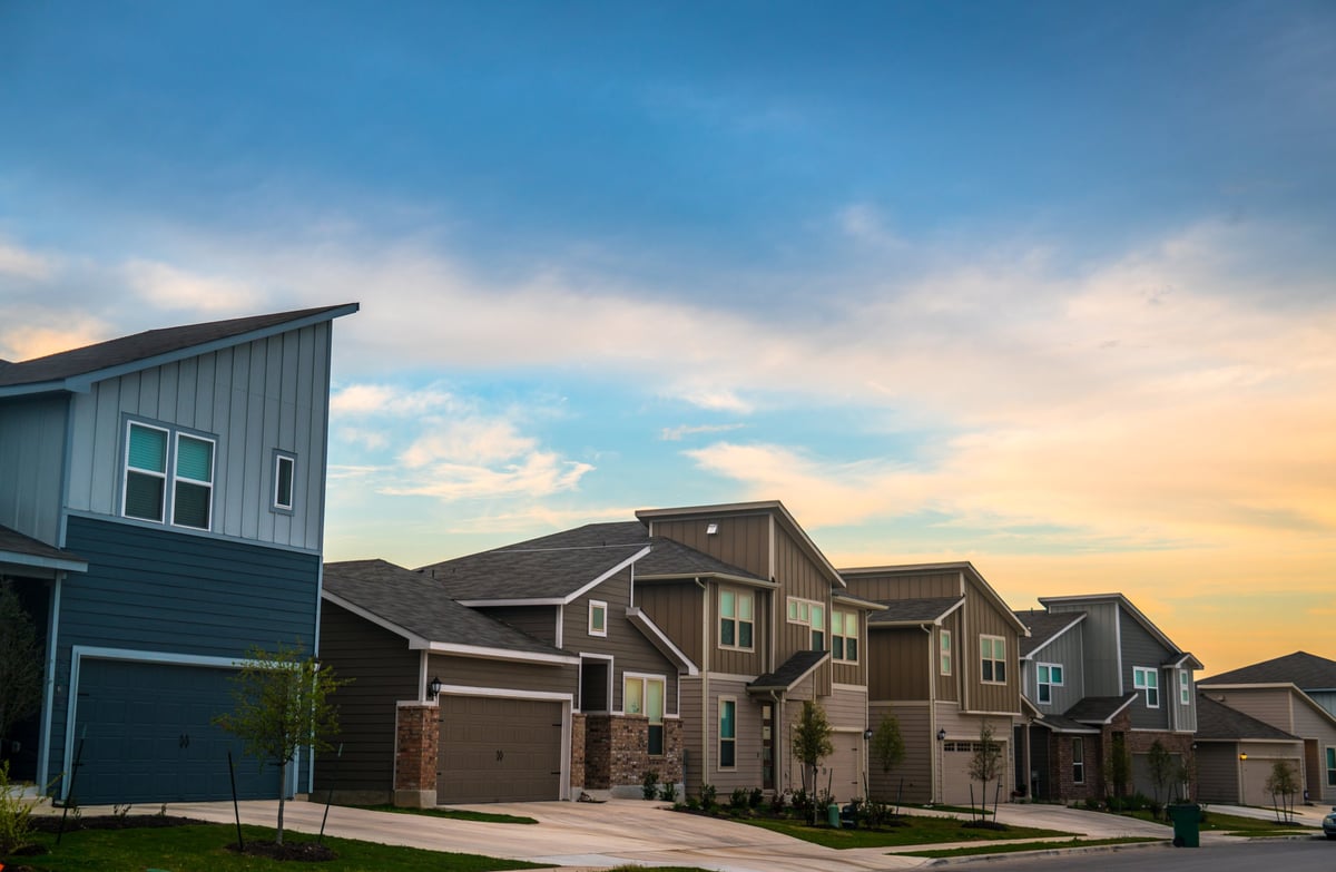 Evening sunlight on the facades and front yards of new homes in a Central Texas neighborhood